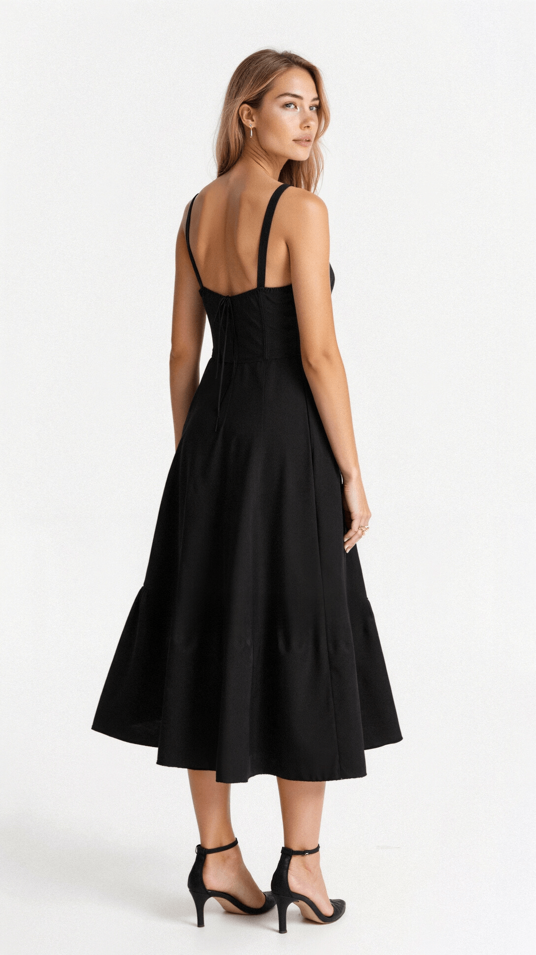 Black fitted midi dress with back straps and flared skirt