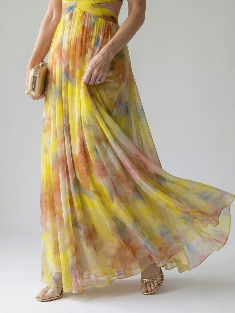 Detail view of flowing multicolor wrap maxi skirt and wide chiffon hem