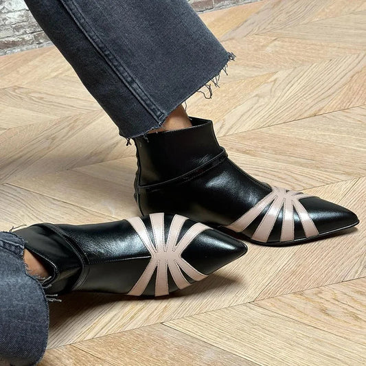 Black pointed-toe ankle boots with geometric light stripe star detail and ankle strap