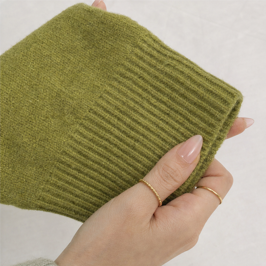 Olive green knit cardigan cuff with ribbed texture