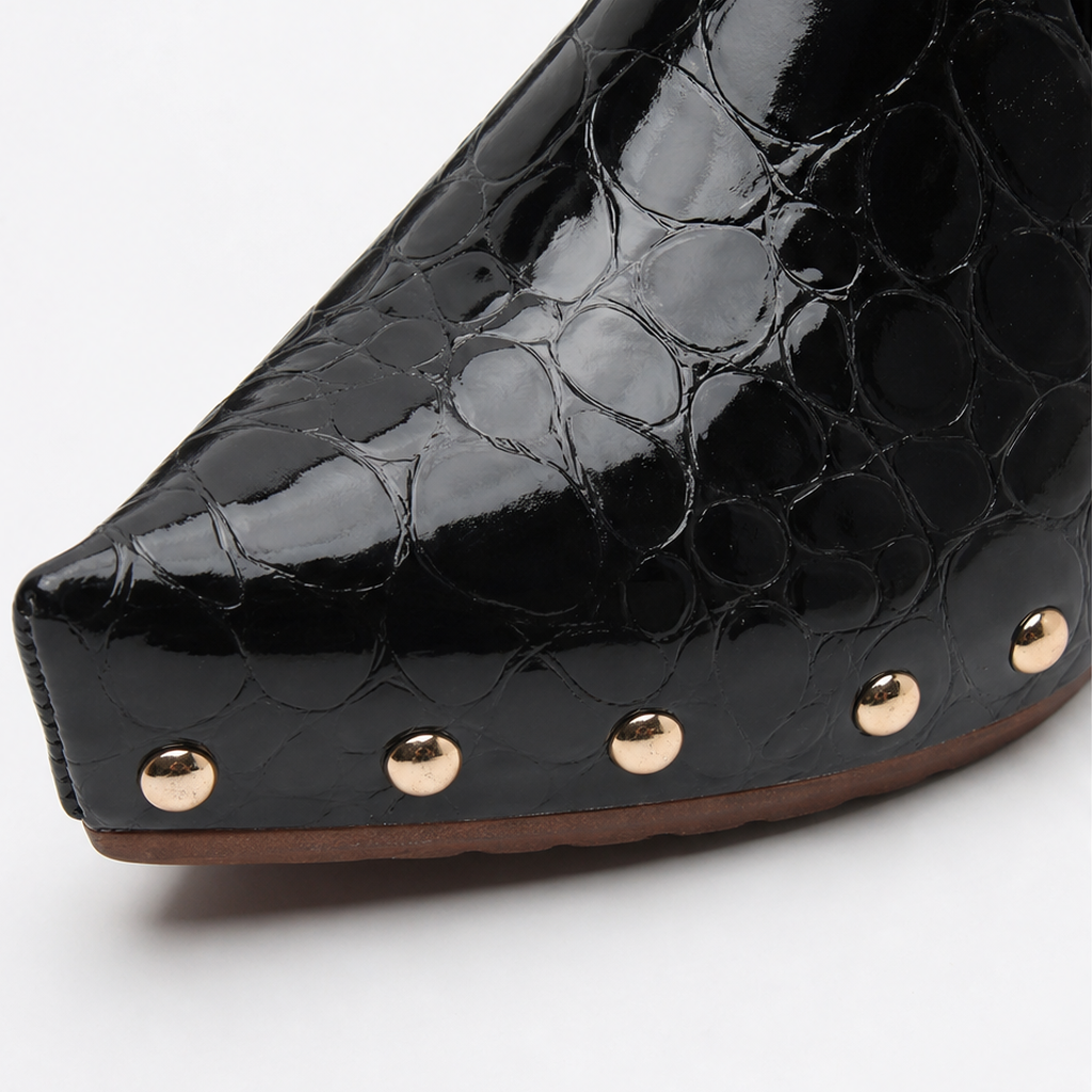 Black croc-embossed clog mule front with gold dome studs and curved wooden sole