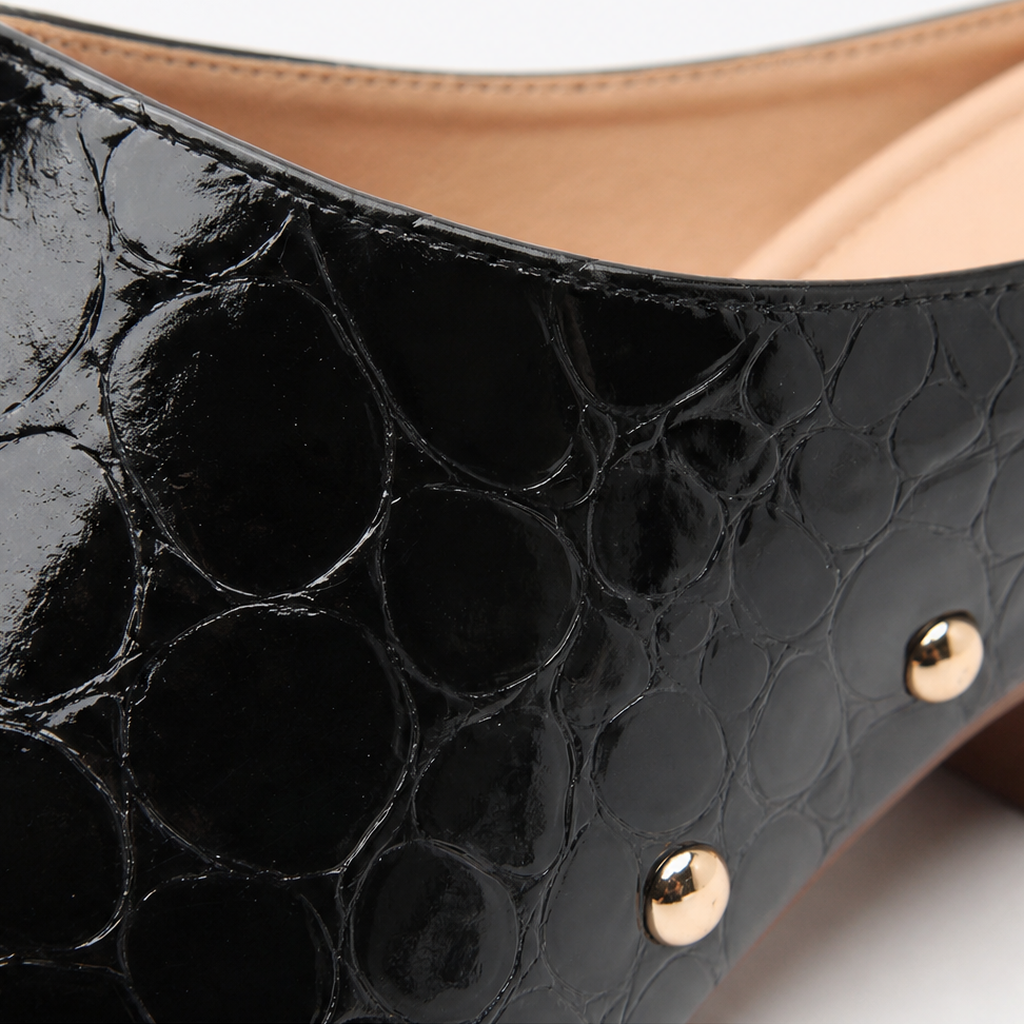 Black croc-embossed clog mule upper with glossy finish and gold dome trim studs