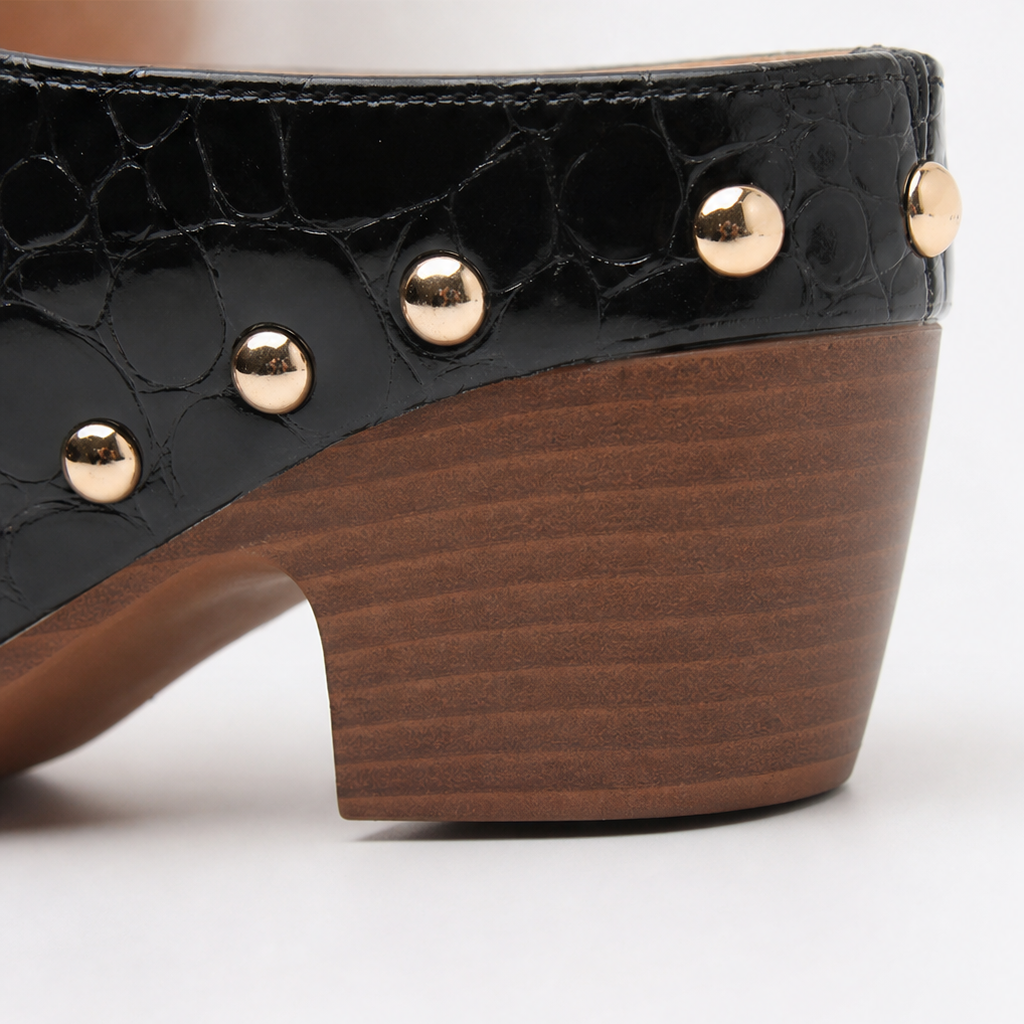 Black croc-embossed clog mule with gold dome studs and brown wooden wedge heel