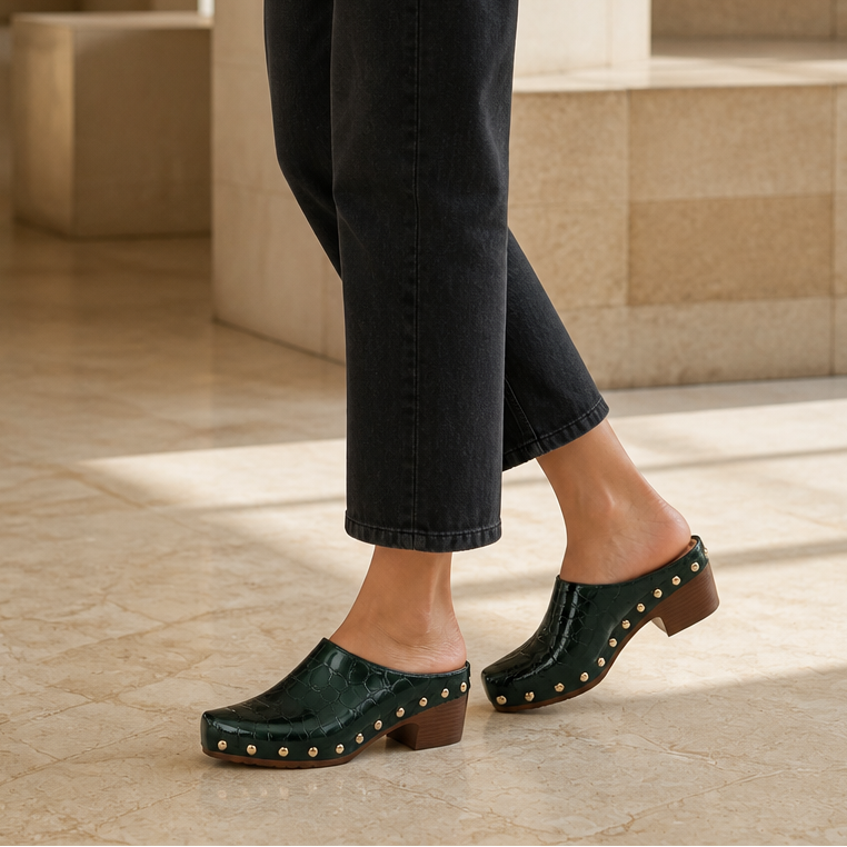 Green croc-embossed clog mules with gold dome studs and chunky wooden heel