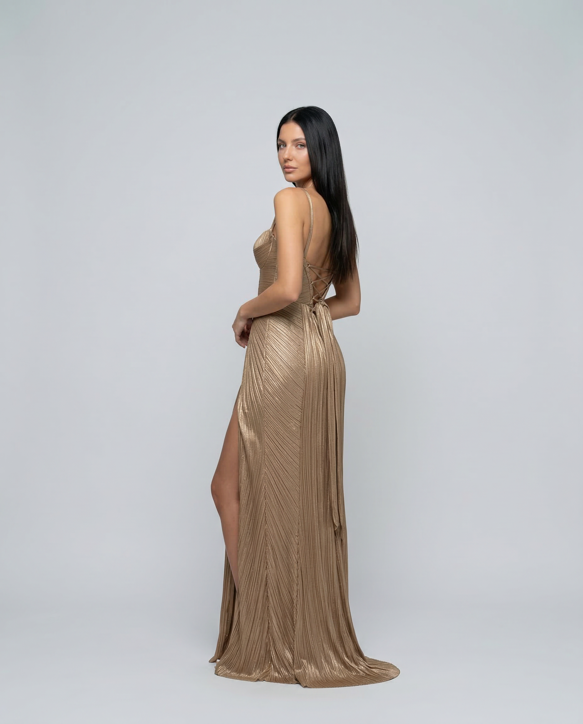 Gold pleated corset-style maxi dress with side slit and spaghetti straps