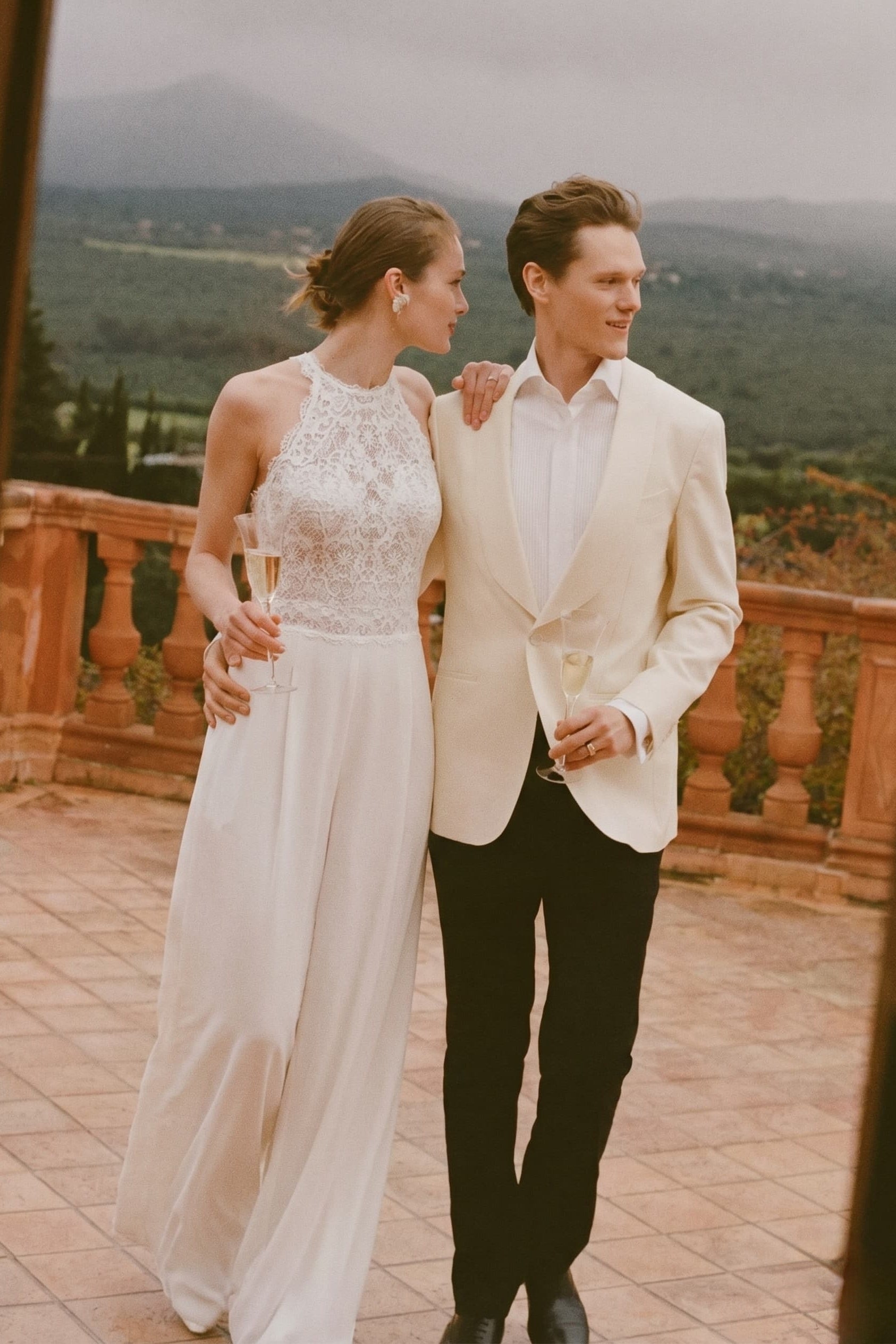 Ivory halter lace jumpsuit, wide-leg trousers with flowing floor-length silhouette