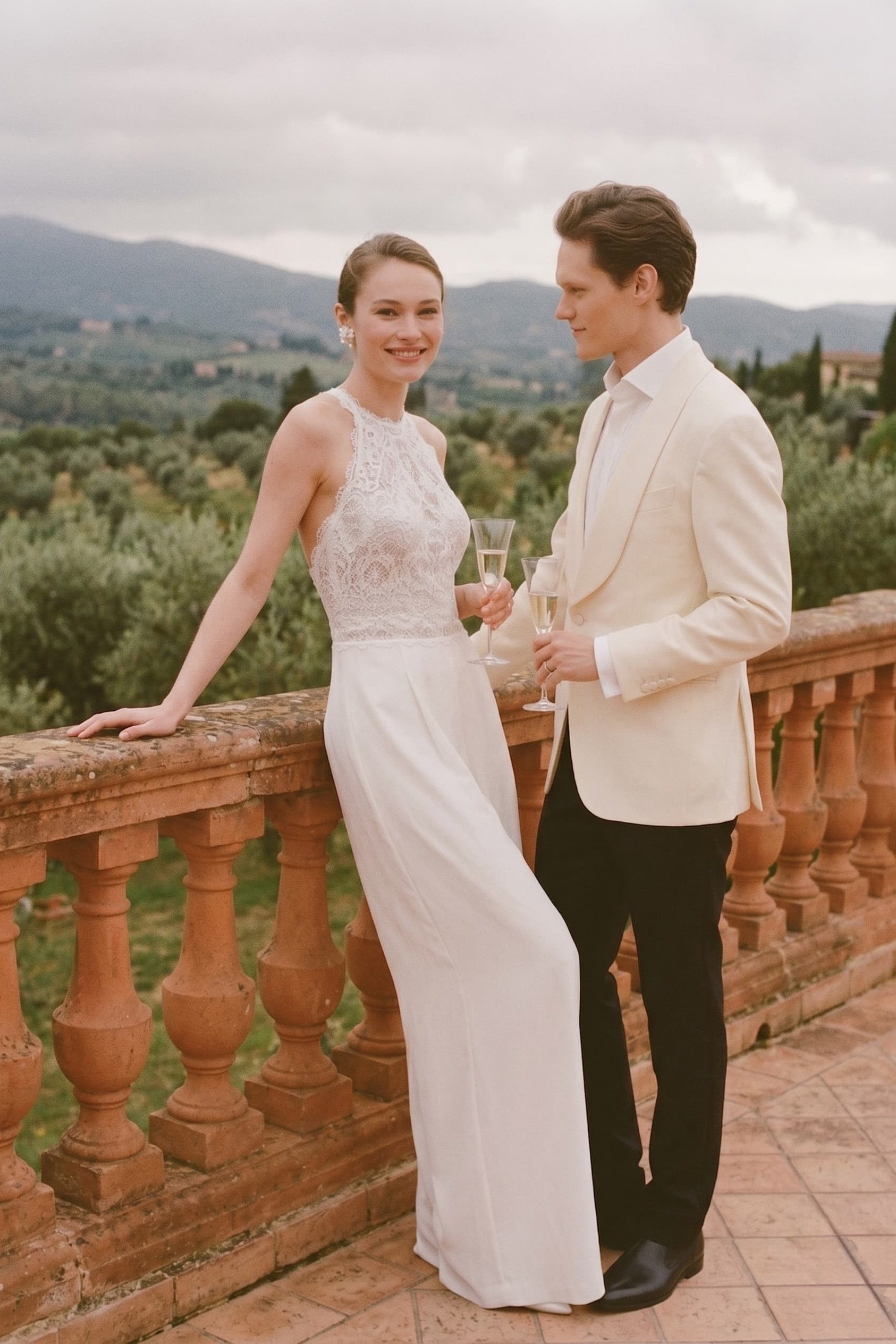 Ivory sleeveless halter jumpsuit with lace top and long wide-leg pant legs