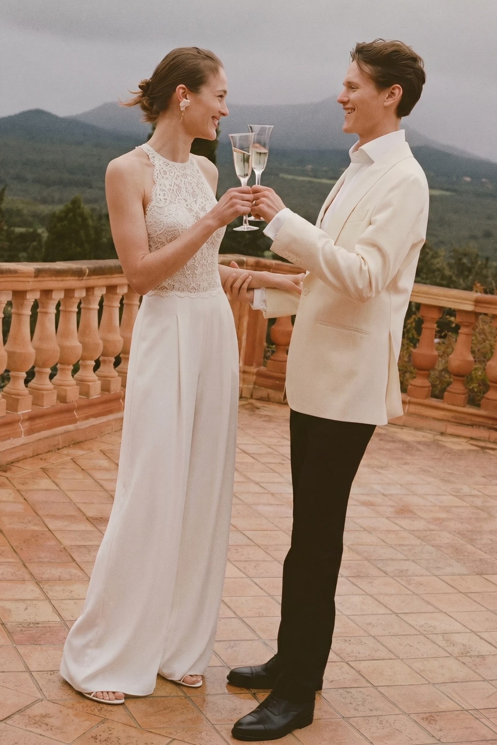 Ivory floor-length halter jumpsuit with lace bodice and wide-leg drape