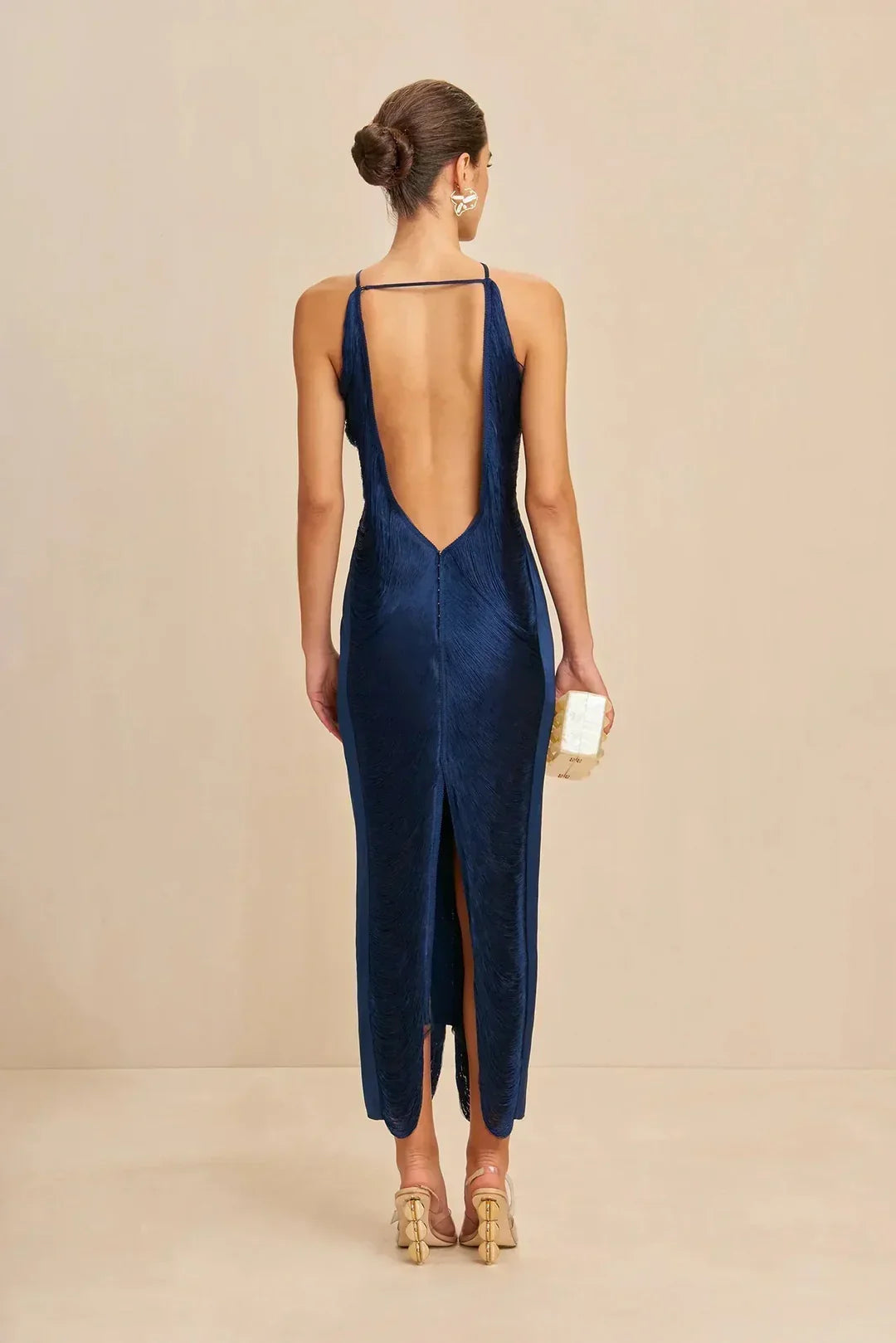 Ink blue halter maxi dress, back view with open straps and center slit