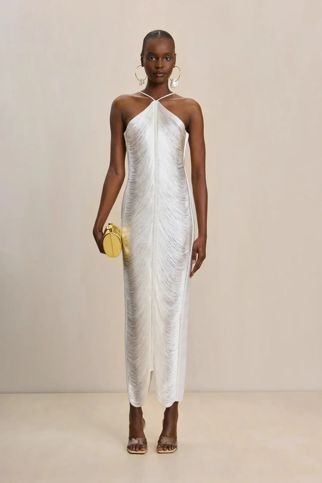 Ivory halter maxi dress with draped fabric and long fringe trim