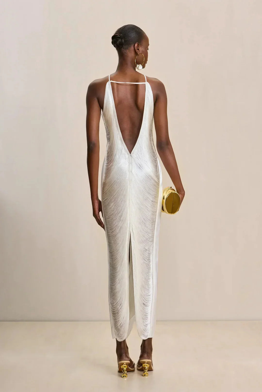 Ivory halter maxi dress, open V-back and draped texture with long hem fringe