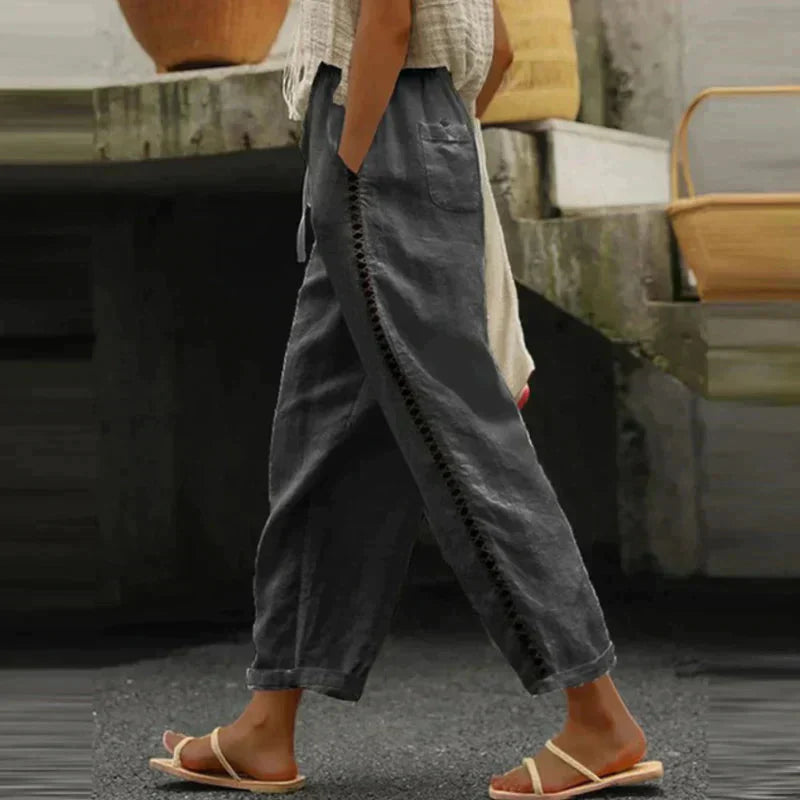 High-waisted tapered trousers in dark color with side button stripe