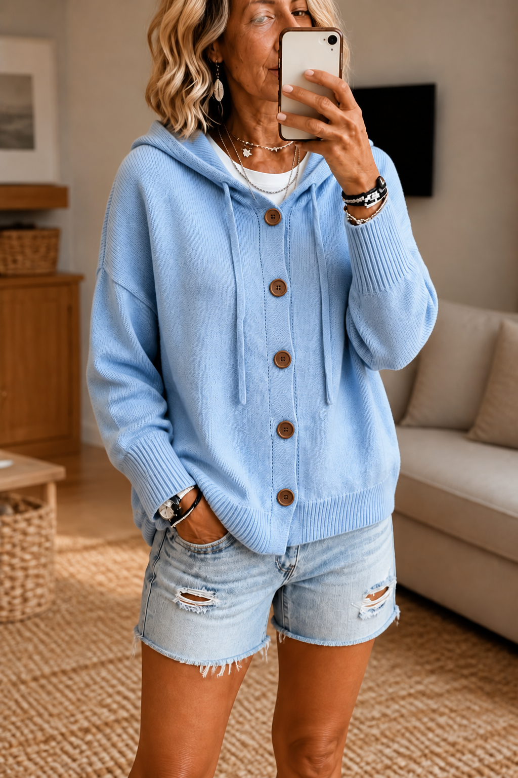 Light blue hooded rib-knit cardigan with drawstrings, brown buttons, and ribbed trim