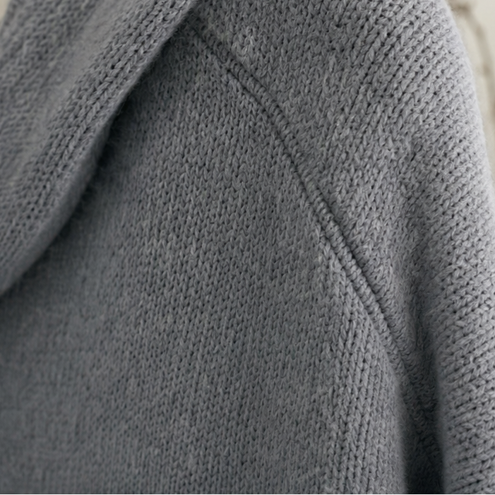 Grey cardigan shoulder and hood seam in textured knit