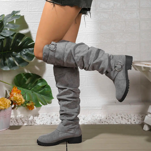Light gray knee-high boots with side buckle strap rings and chunky rubber sole