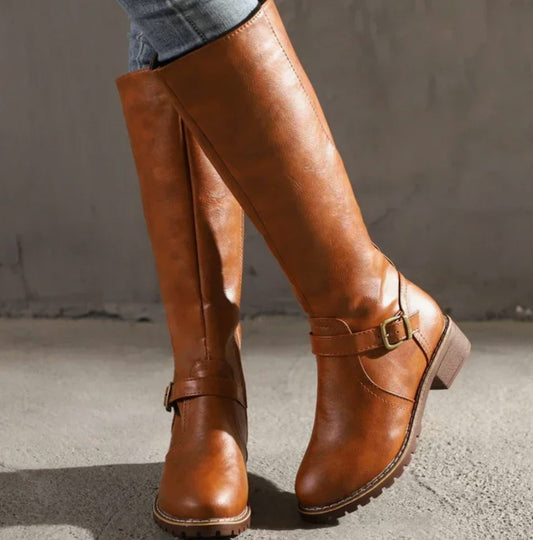 Cognac brown knee-high buckle-strap boots with chunky sole and block heel.
