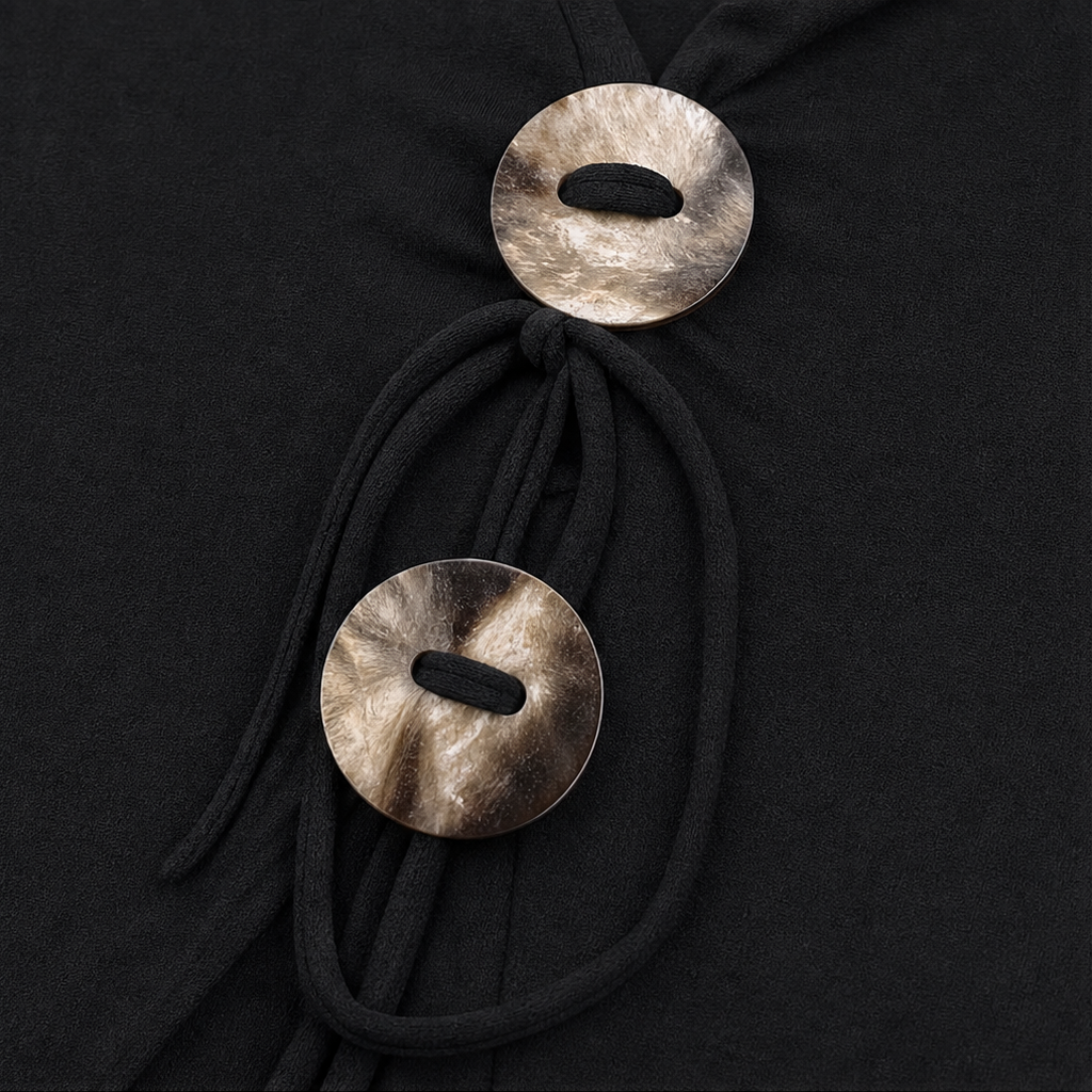 Knotted V-neck knit top closeup: round metal-style front tie buttons