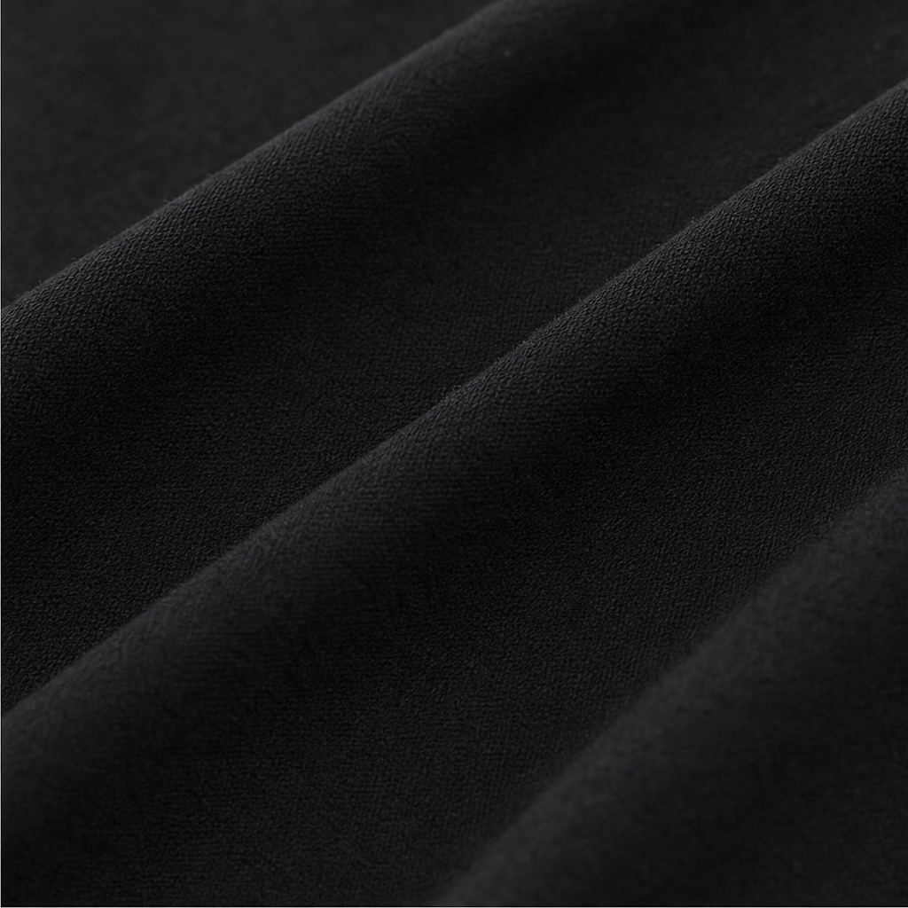 Black knit fabric texture closeup for knotted V-neck top