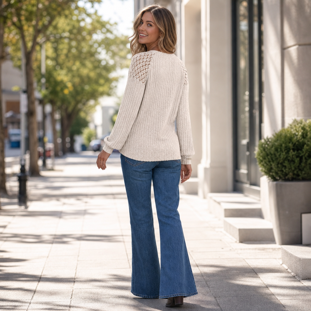 Ribbed cream long-sleeve top with lace shoulder overlay and button accents, relaxed fit.