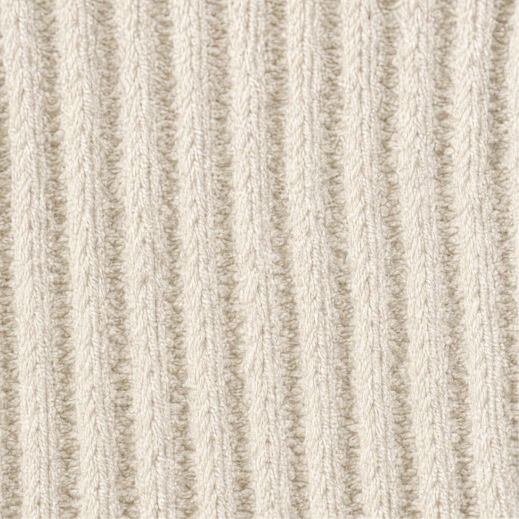 Close-up of cream ribbed knit texture on long-sleeve top fabric, vertical cable-like lines.