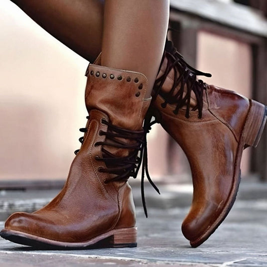 Brown mid-calf lace-up boots with studded cuff detail and dark lace-up straps