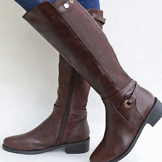 Brown leather knee-high riding boots with side buckle and decorative hardware