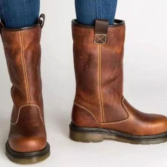 Brown fleece-lined ankle boots with pull-on panels, strap buckle and rubber sole