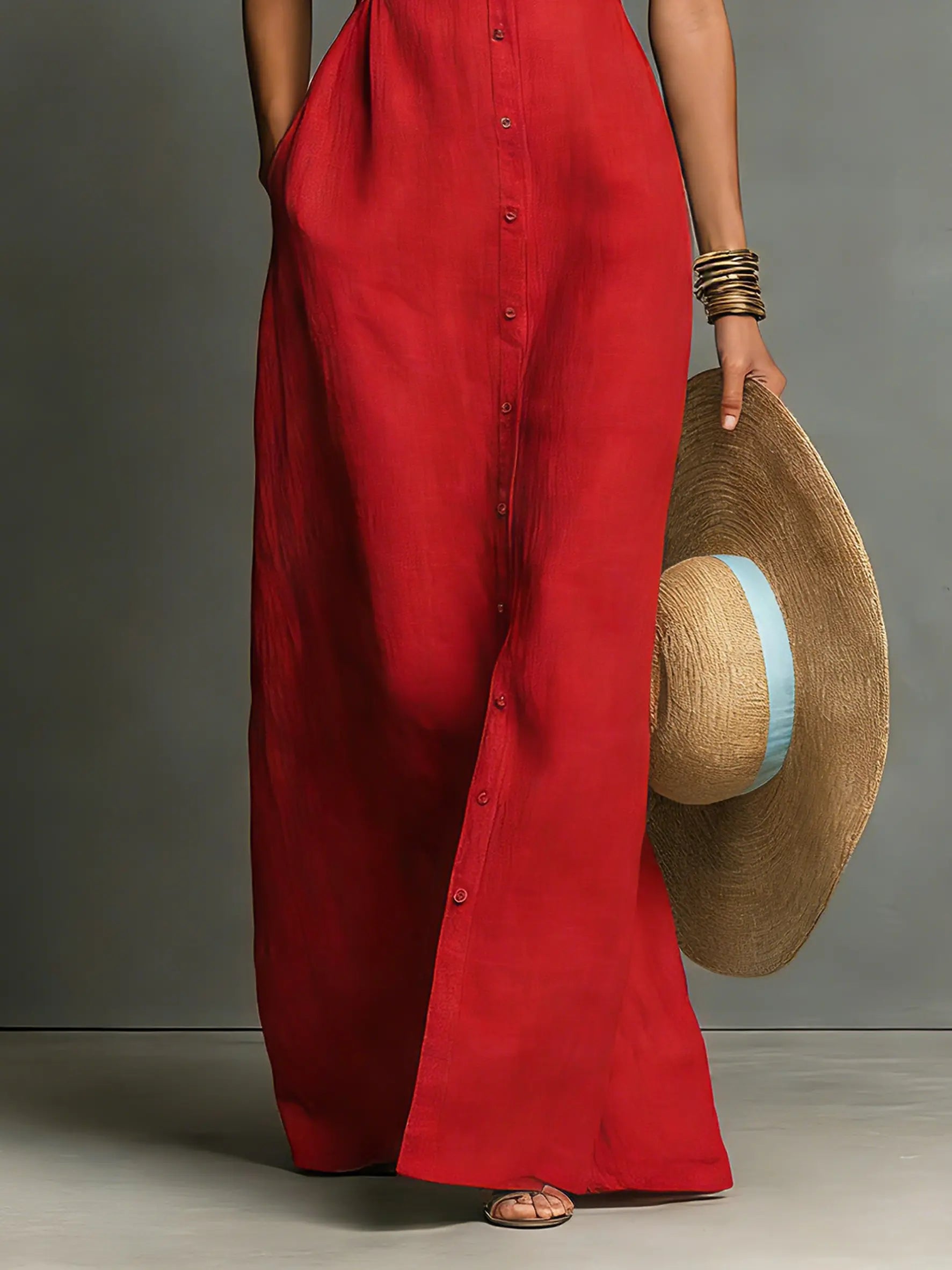 Red linen maxi sleeveless shirt dress close-up showing button placket and draped hem