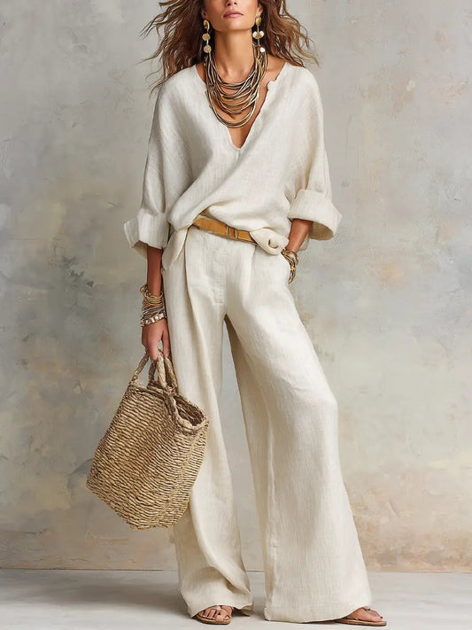 White linen two-piece set with loose V-neck blouse and wide-leg pants