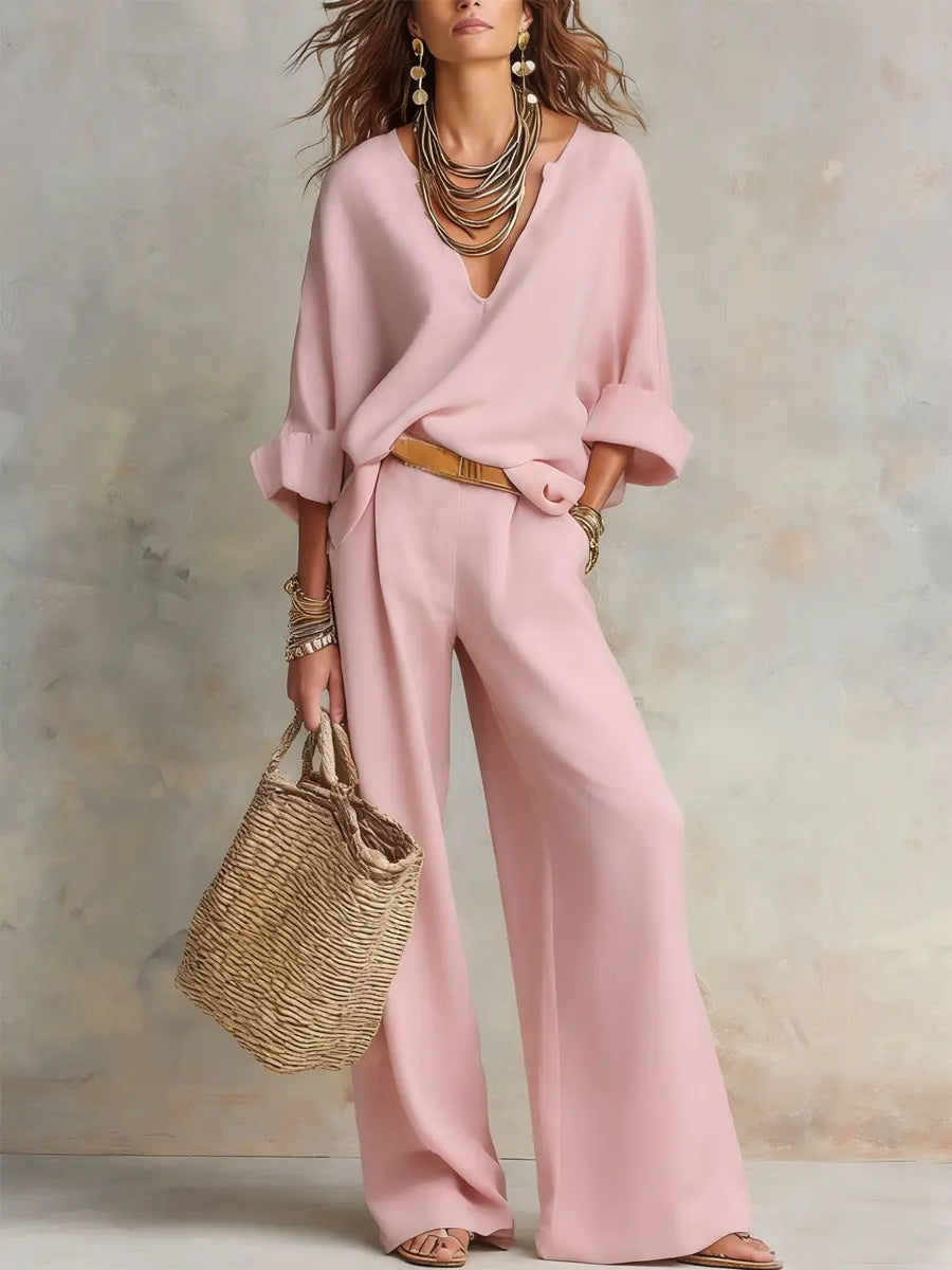 Pink linen two-piece set with V-neck blouse and wide-leg trousers, tan belt
