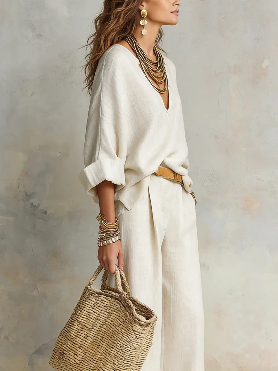White linen two-piece set with loose blouse and wide-leg pants, side view