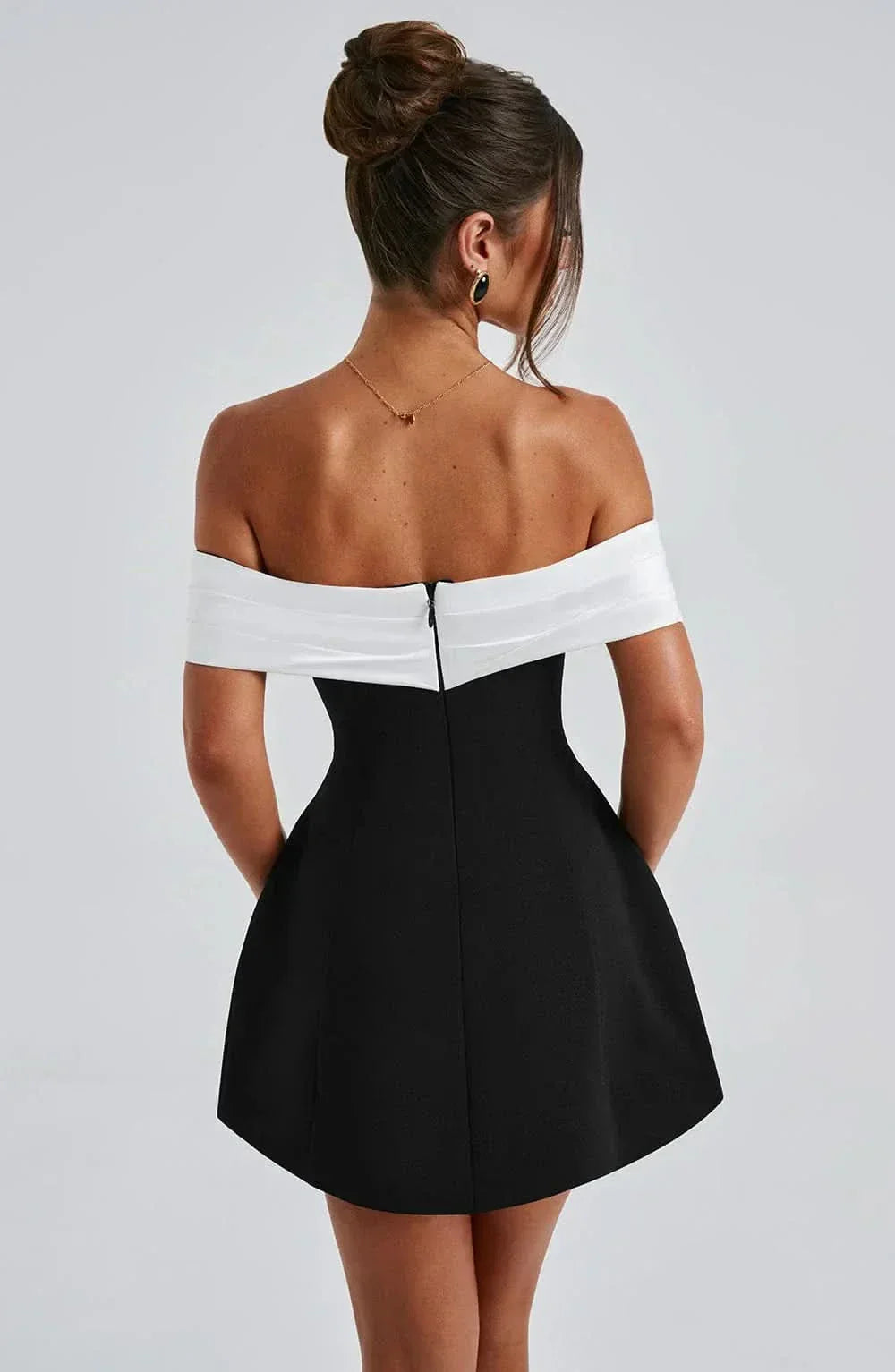 Black off-shoulder mini dress with paneled back and fitted flare skirt