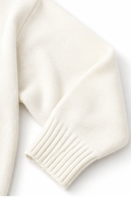 White knit sweater sleeve with soft ribbed cuff and textured knit finish