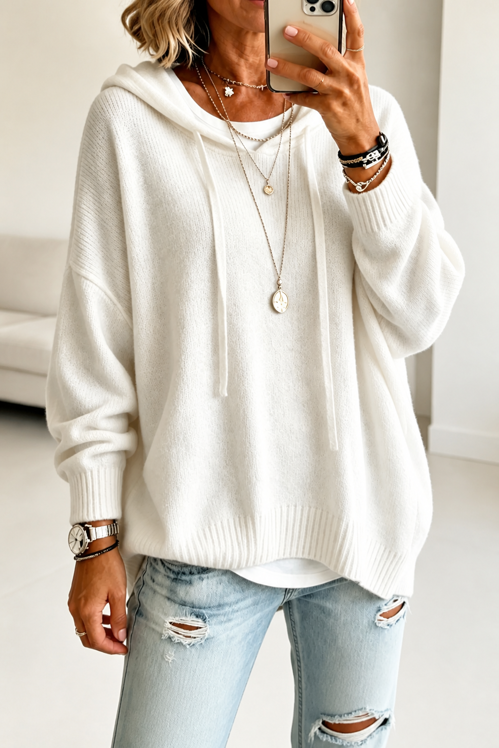 White oversized knit hooded sweater with drawstring hood and ribbed hem