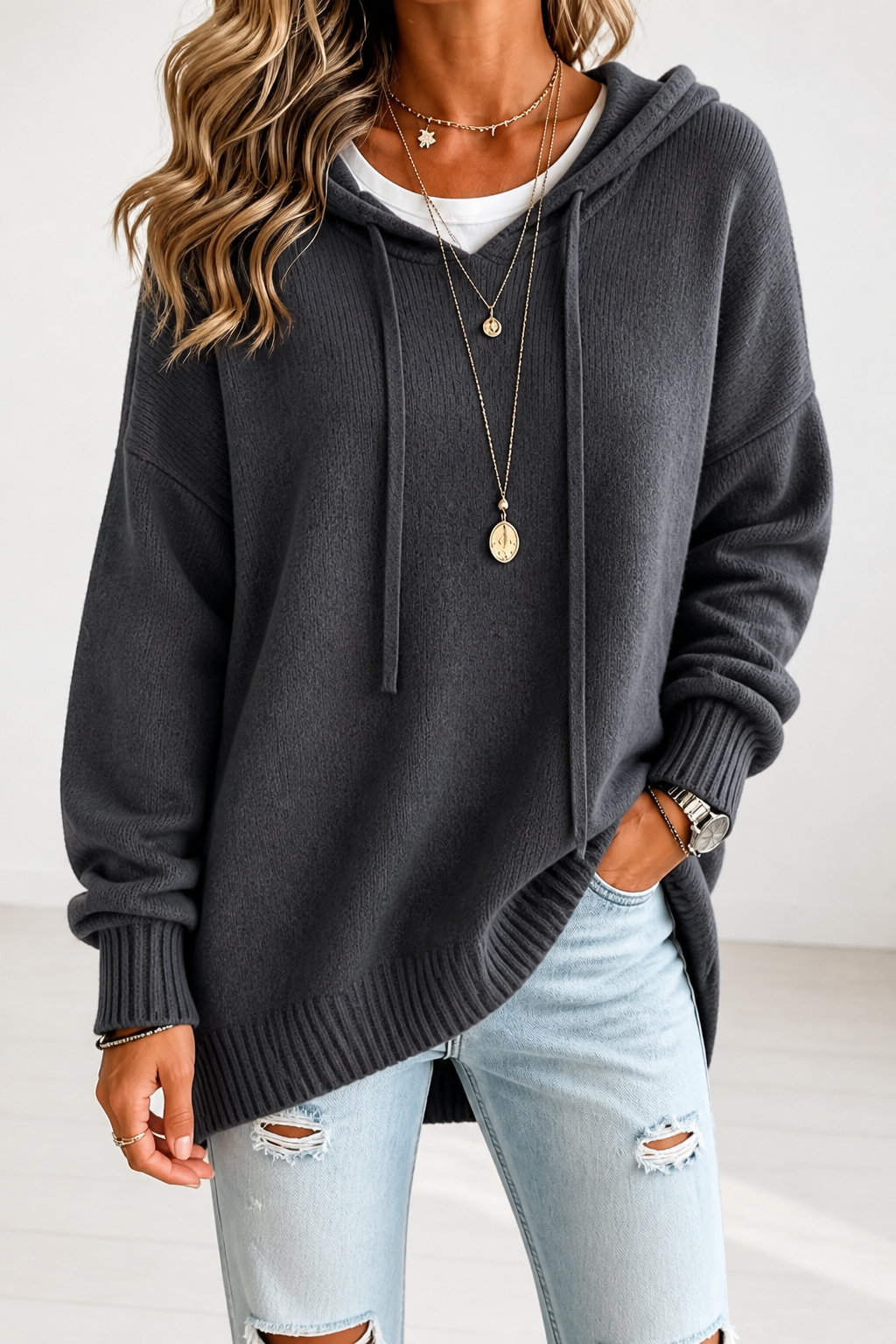 Charcoal gray oversized knit hooded sweater with drawstring, ribbed cuffs.