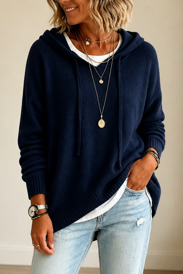 Navy blue oversized knit hooded sweater with drawstring and ribbed cuffs.