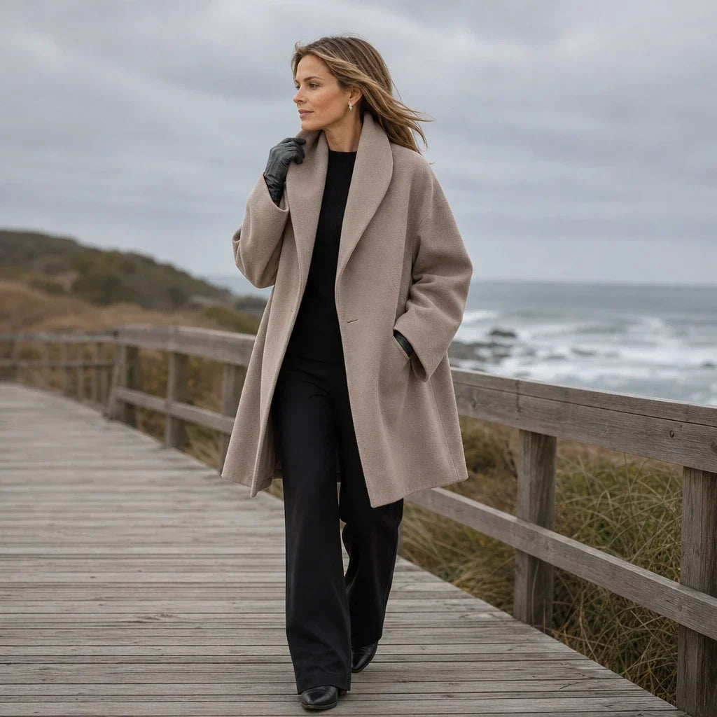 Full-length view of an oversized taupe coat with open front and wide lapels.