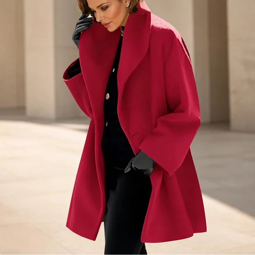 Red oversized coat with wide lapels, long sleeves, and a flared hem