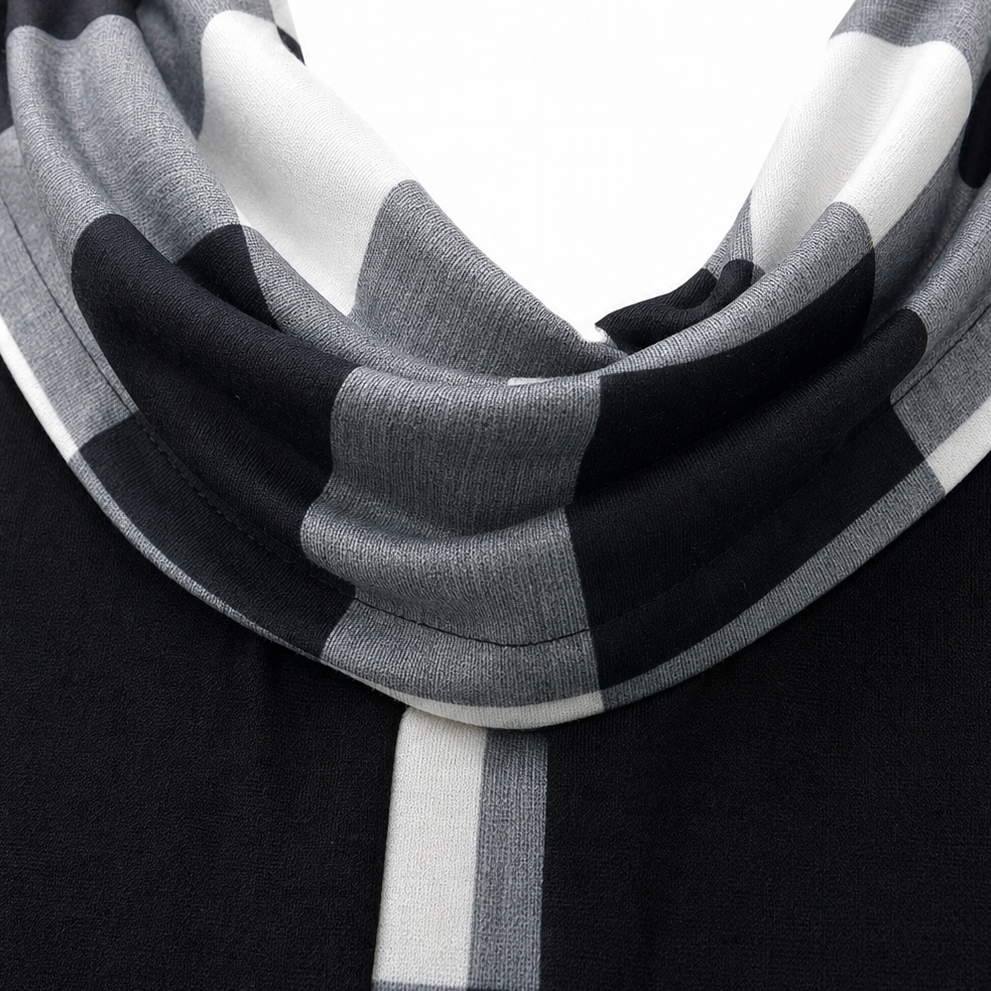 Plaid cowl neckline close-up on black tunic