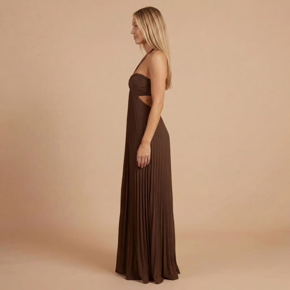 Dark brown pleated halter maxi dress in profile, with waist cutouts and halter straps