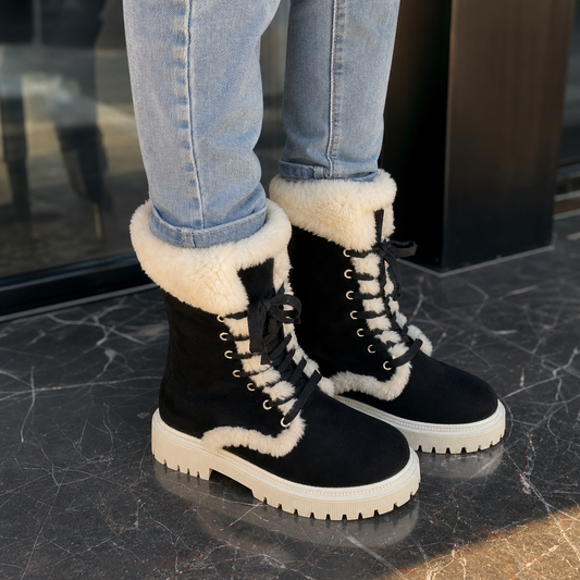 Black mid-calf lace-up boots with plush sherpa lining and thick lug sole