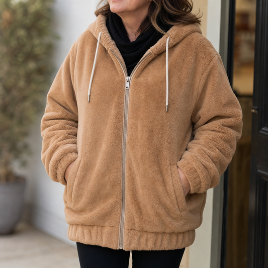 Plush-lined hooded vest with full front zipper, drawstring hood, tan/beige color.