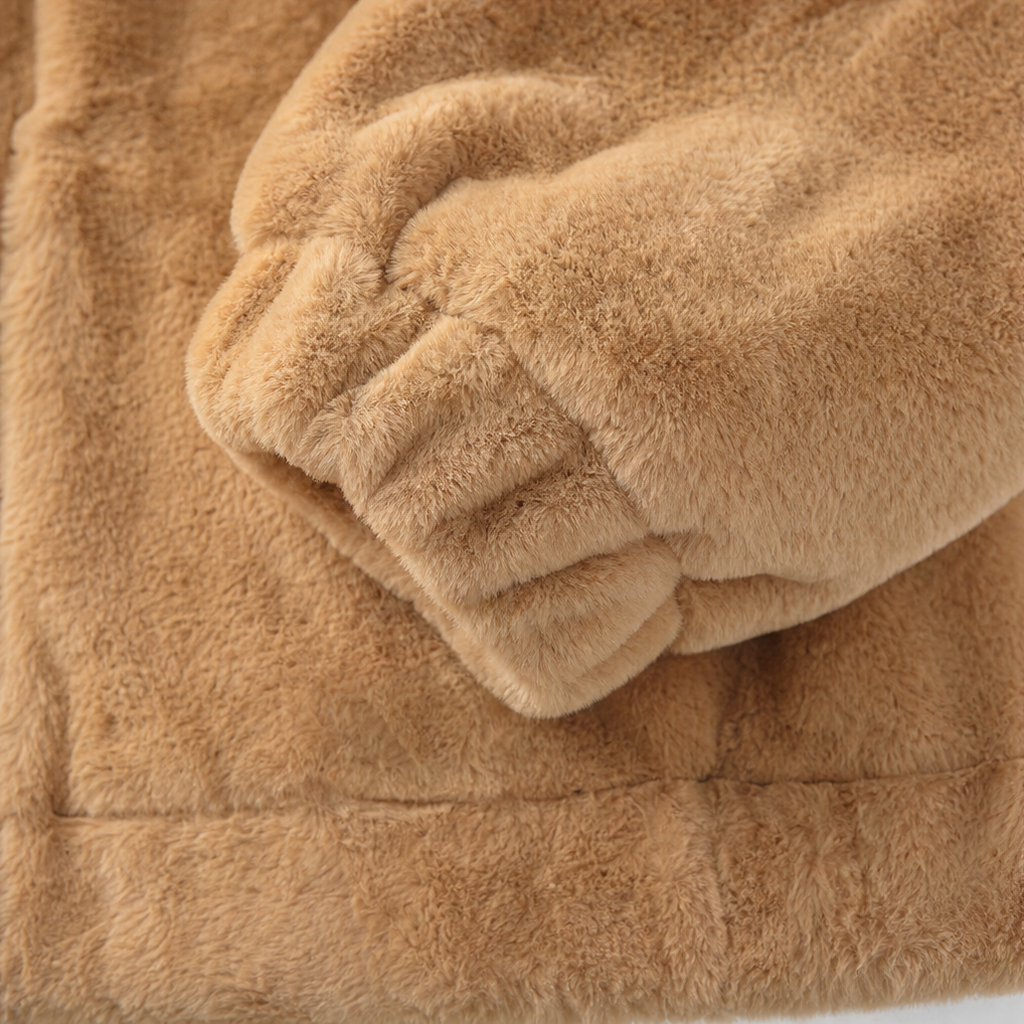 Tan/beige plush cuff and hem with stitched seam detail on a hooded vest.