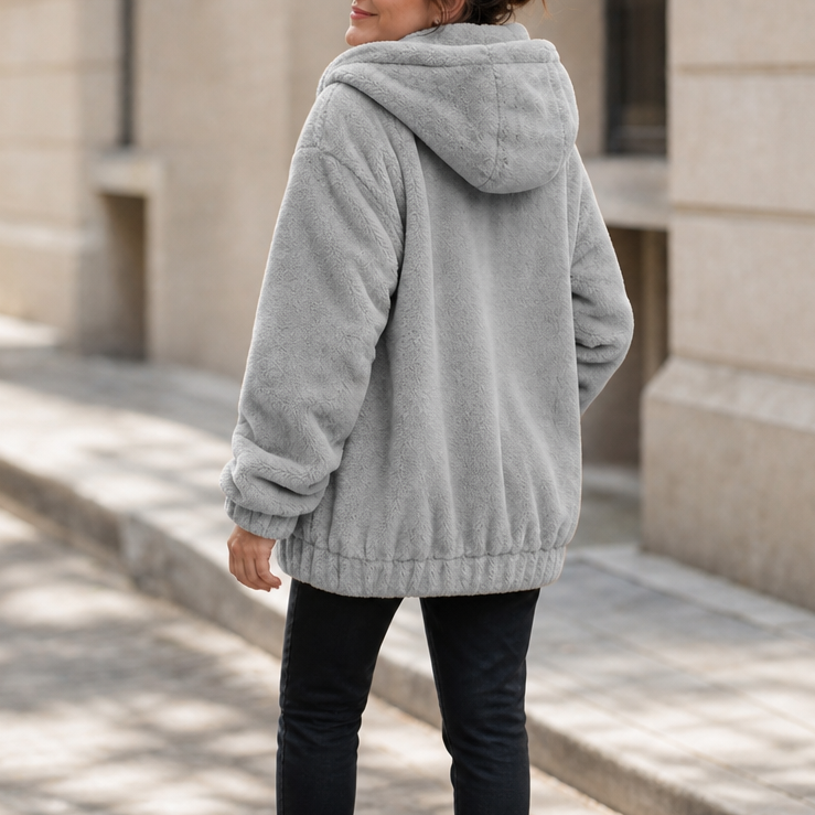 Gray plush-lined hooded vest with front kangaroo pocket and fluffy fleece texture