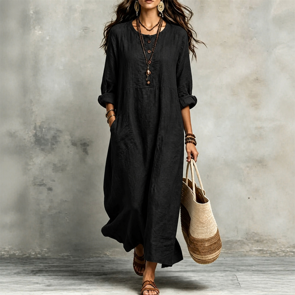 Black pocketed maxi dress with button front and elbow-length puff sleeves.