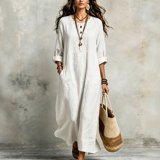 White pocketed maxi dress with button placket and loose three-quarter sleeves.