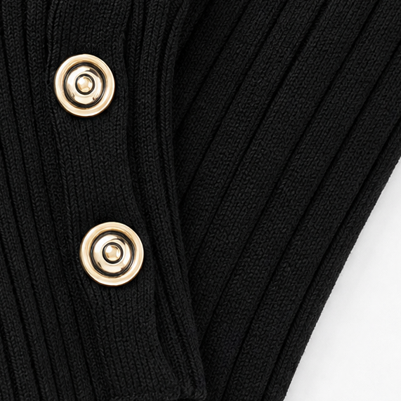 Close-up of black ribbed cuff with gold-tone button details