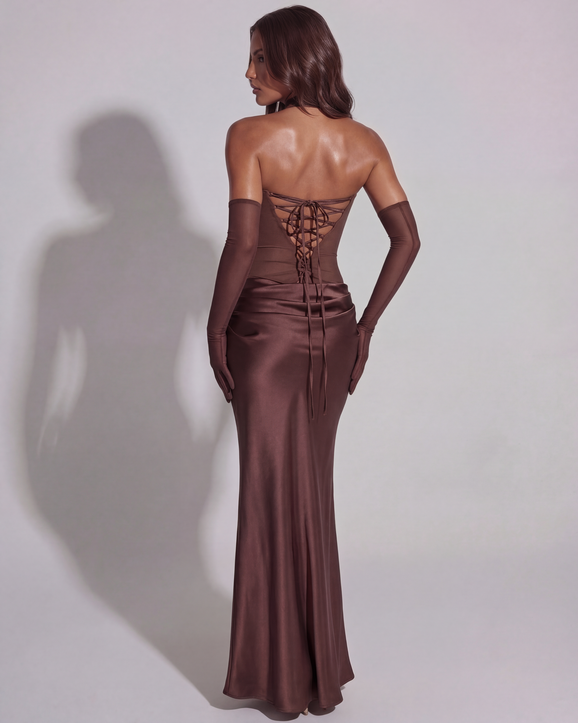 Brown satin maxi dress with cowl neckline and lace-up back detail