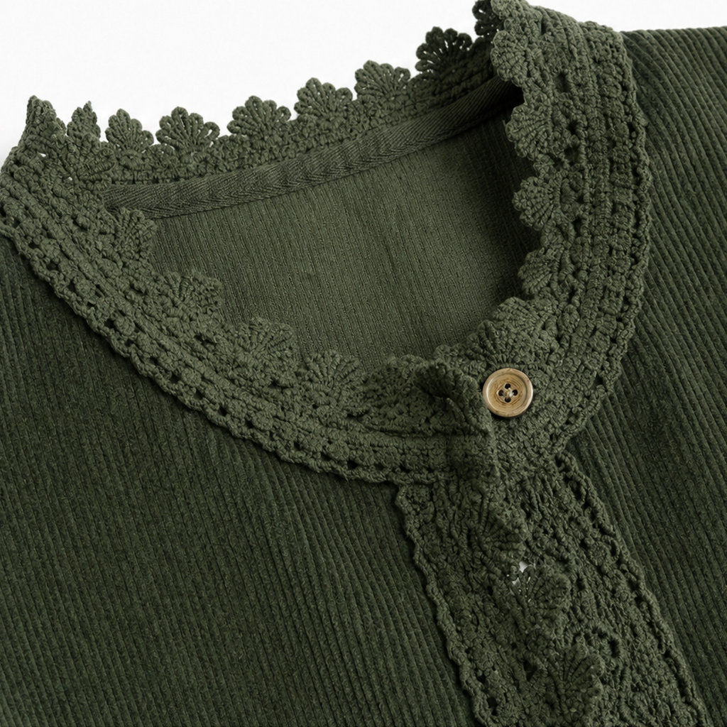 Close-up of green corduroy-look jacket neckline with scalloped lace trim and button