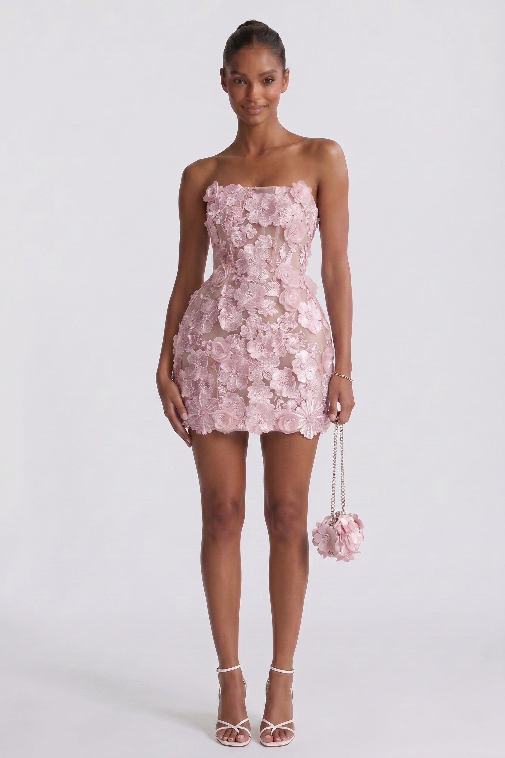 Pink strapless sheath mini dress with 3D floral overlay and matching floral pouch